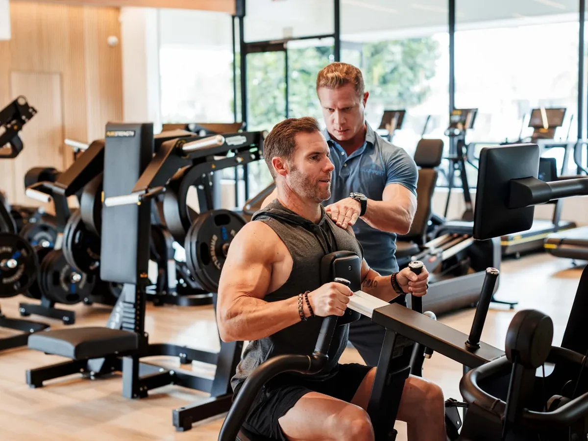 Coach guiding a member through a training session at Bluprint Wellness